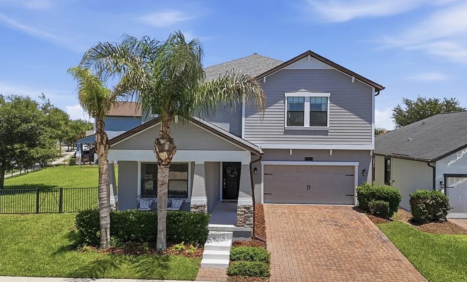 Two-story single-family home with palm trees in Central Florida
